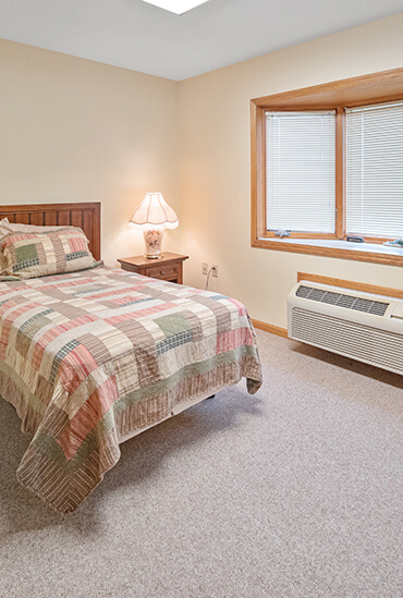 Victorian Legacy assisted living apartment bedroom at Good Samaritan Society - Superior