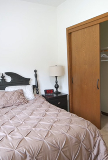 Assisted living apartment bedroom at The Lodge of Taylors Falls by Good Samaritan Society 