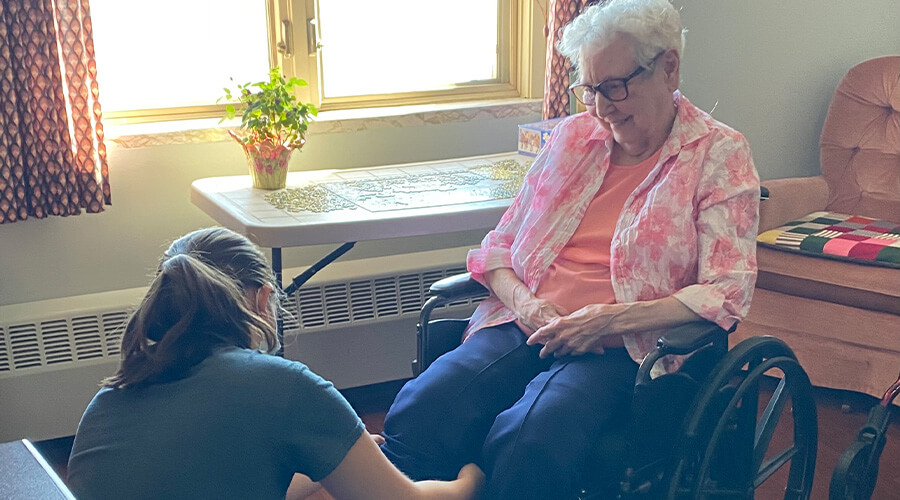 Good Samaritan Society staff member assisting a senior female resident.
