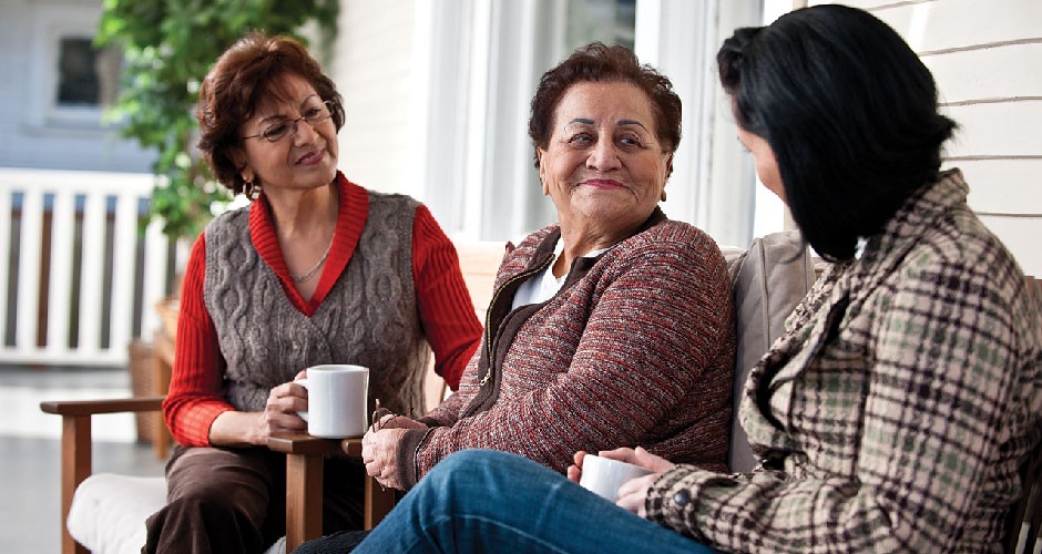 3 woman chatting over coffee.