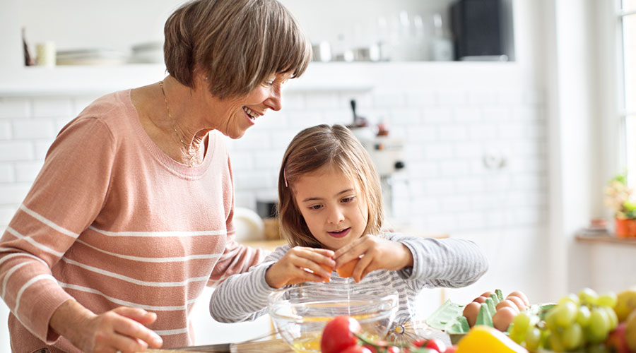 Grandma cooking with her grandkid.