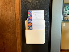 Shopping list on the side of the refrigerator