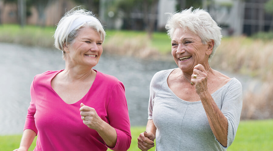 Two senior-aged women walking for exercise.