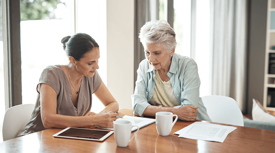 Stock photo of middle-aged woman talking to senior woman