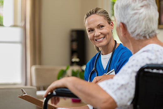 Nurse talking to a patient at home.