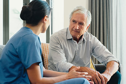 Senior talking to a nurse.