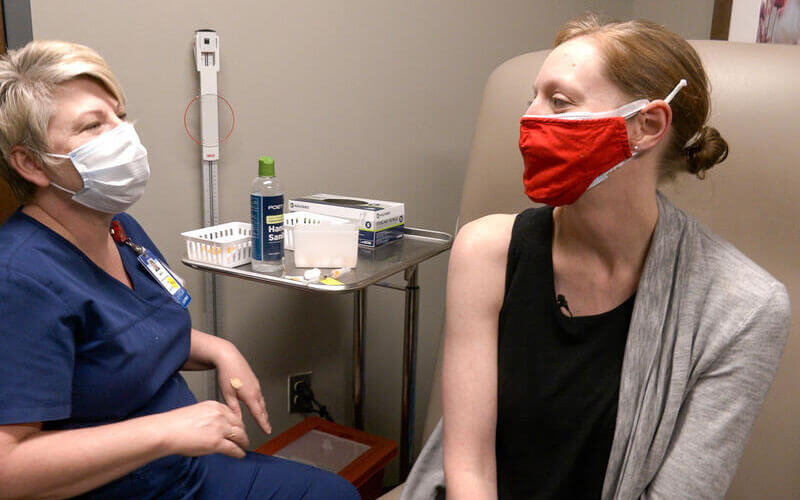 Nurse helping a patient.