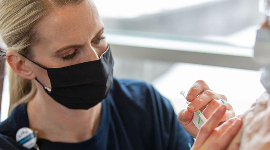 Nurse helping a patient.