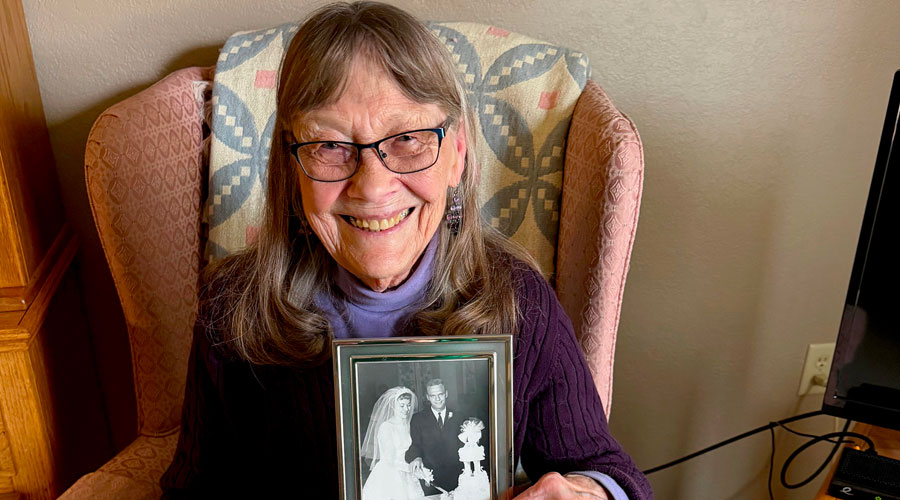 Joan Watson holding her wedding photo.