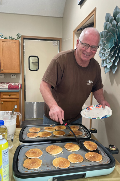 Dave flipping pancakes.