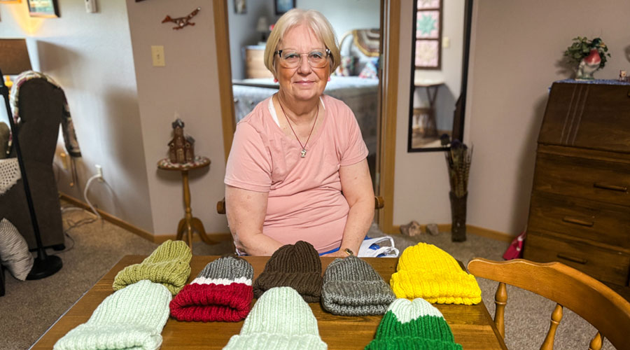 Good Samaritan Society – Ridge View Estates resident, Dianne Brockberg, displaying some of the hats she knitted.