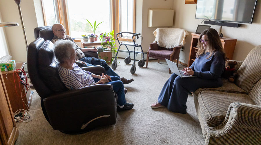 Ever Forward recipient Sarah Angelo makes easy connections with a couple in their home.