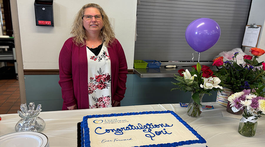 Lori Johnson with a celebratory cake.