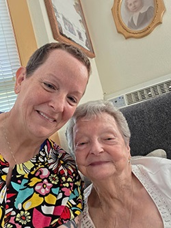 Pauline Daninger smiling with a nurse.