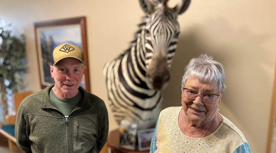 The Bensons standing in front of zebra art.