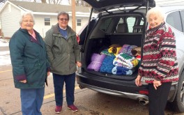 The Hastings Village knitters group delivers blankets to the Morrison Cancer Center.