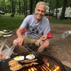 Bill Gran cooking at campfire