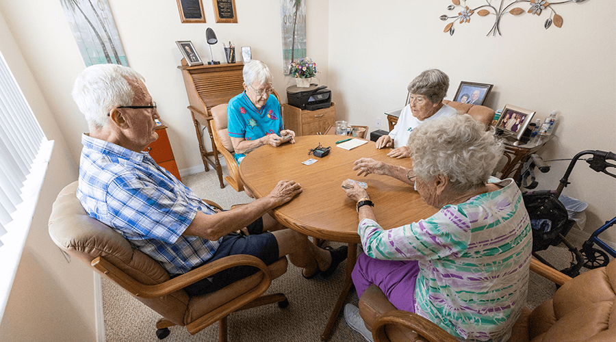 Four residents playing cards at Kissimmee Village