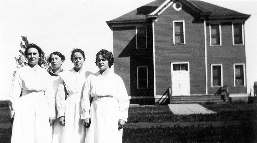 Four female nurses in front of Society building in 1923