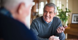Adult man talks to his father about the benefits of moving to a Good Samaritan Society assisted living community