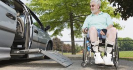 Man in wheelchair approaching ramp in van